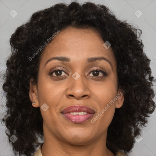 Joyful black adult female with long  brown hair and brown eyes