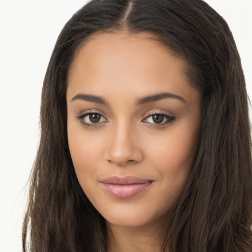 Joyful latino young-adult female with long  brown hair and brown eyes