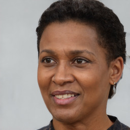 Joyful black adult female with short  brown hair and brown eyes