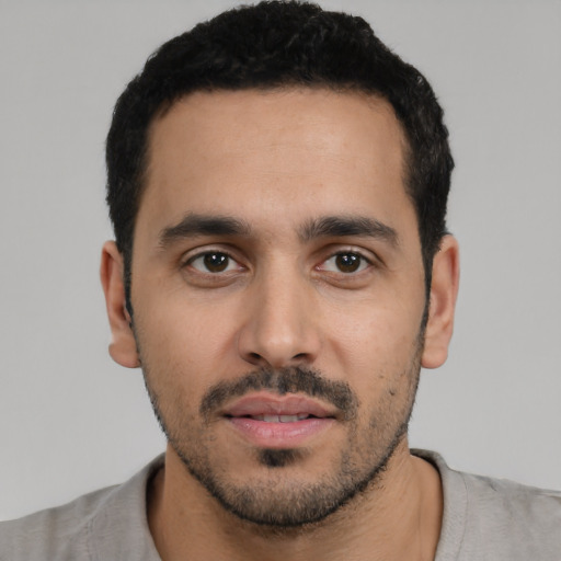 Neutral latino young-adult male with short  black hair and brown eyes