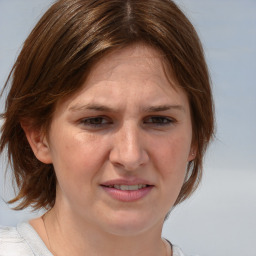 Joyful white adult female with medium  brown hair and blue eyes