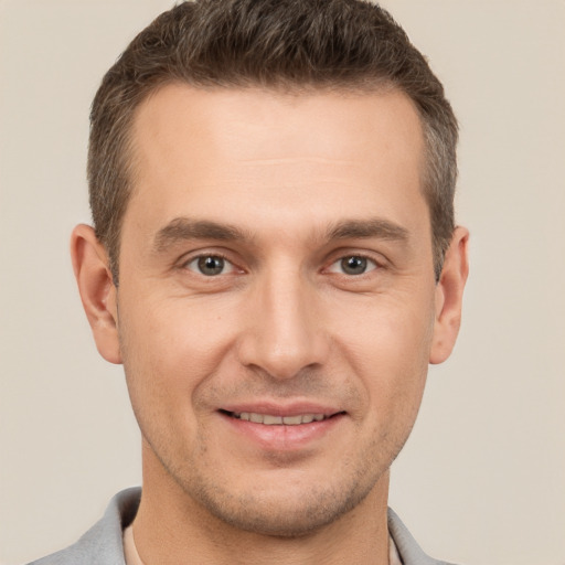 Joyful white adult male with short  brown hair and brown eyes