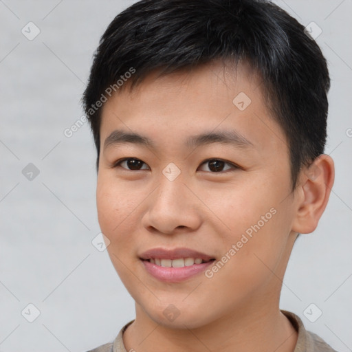 Joyful asian young-adult male with short  brown hair and brown eyes
