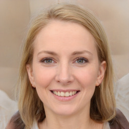 Joyful white young-adult female with medium  brown hair and blue eyes