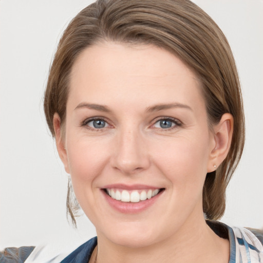 Joyful white young-adult female with medium  brown hair and grey eyes