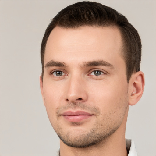 Joyful white young-adult male with short  brown hair and brown eyes