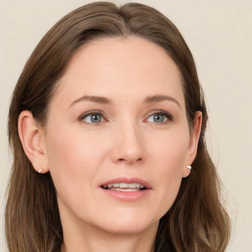 Joyful white young-adult female with long  brown hair and grey eyes