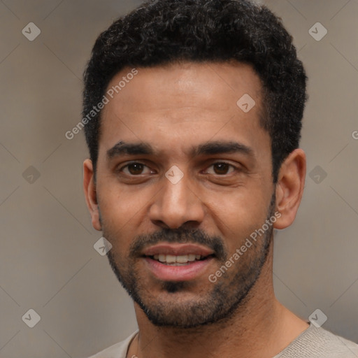 Joyful latino young-adult male with short  black hair and brown eyes