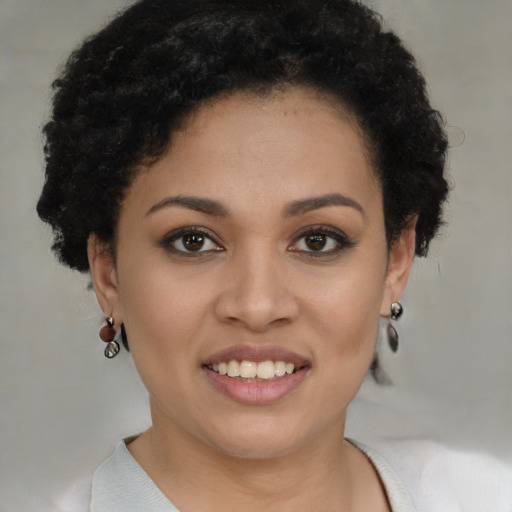 Joyful black young-adult female with short  brown hair and brown eyes