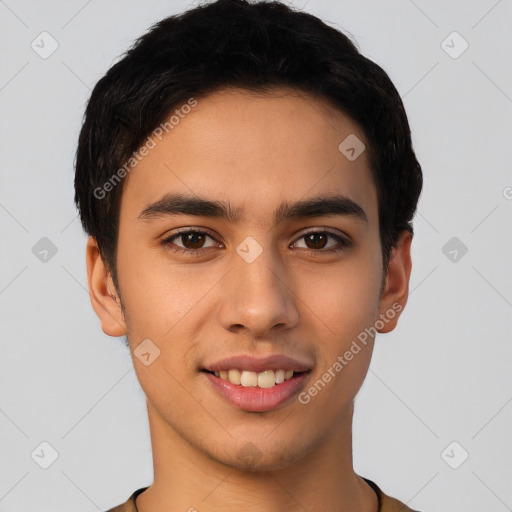 Joyful latino young-adult male with short  brown hair and brown eyes