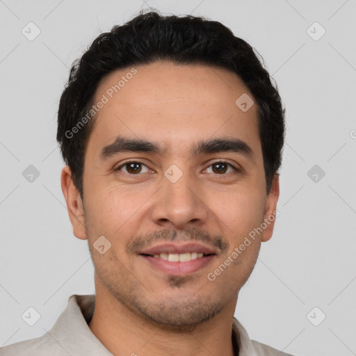 Joyful white young-adult male with short  black hair and brown eyes