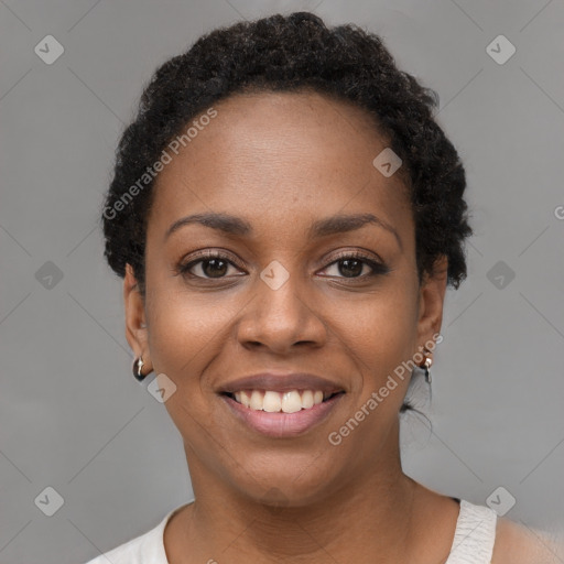 Joyful black young-adult female with short  black hair and brown eyes