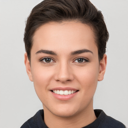 Joyful white young-adult female with short  brown hair and brown eyes