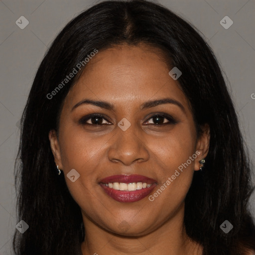 Joyful black young-adult female with long  brown hair and brown eyes