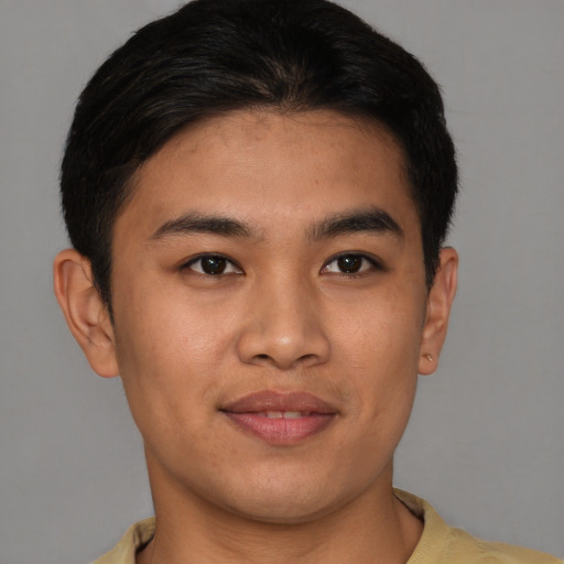 Joyful asian young-adult male with short  brown hair and brown eyes
