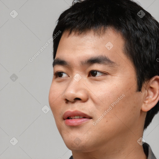 Joyful asian young-adult male with short  black hair and brown eyes