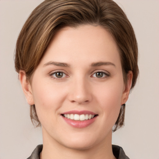 Joyful white young-adult female with medium  brown hair and grey eyes