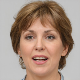 Joyful white adult female with medium  brown hair and grey eyes