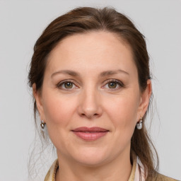 Joyful white adult female with medium  brown hair and grey eyes