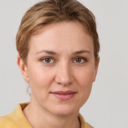 Joyful white young-adult female with short  brown hair and grey eyes