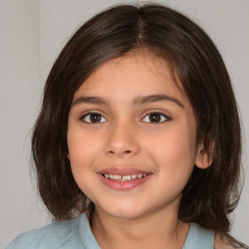 Joyful white child female with medium  brown hair and brown eyes