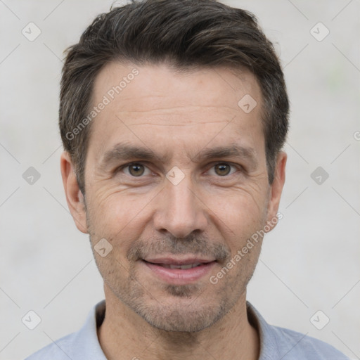 Joyful white adult male with short  black hair and brown eyes