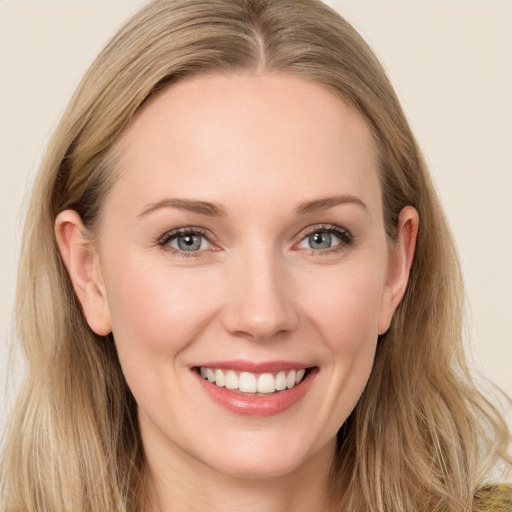 Joyful white young-adult female with long  brown hair and blue eyes