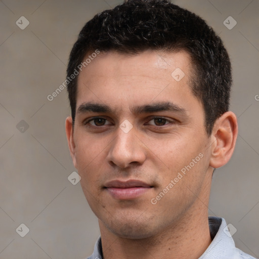 Joyful white young-adult male with short  black hair and brown eyes