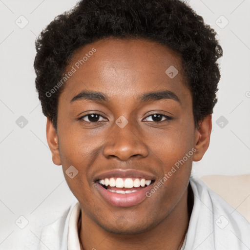 Joyful black young-adult male with short  brown hair and brown eyes