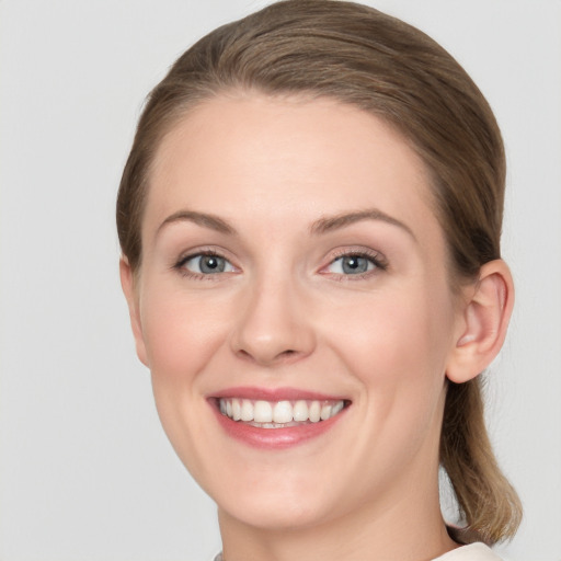 Joyful white young-adult female with medium  brown hair and blue eyes