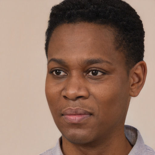 Joyful black young-adult male with short  black hair and brown eyes