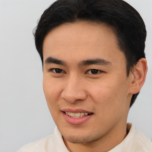 Joyful latino young-adult male with short  brown hair and brown eyes