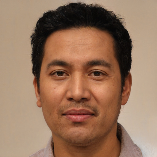 Joyful asian adult male with short  black hair and brown eyes