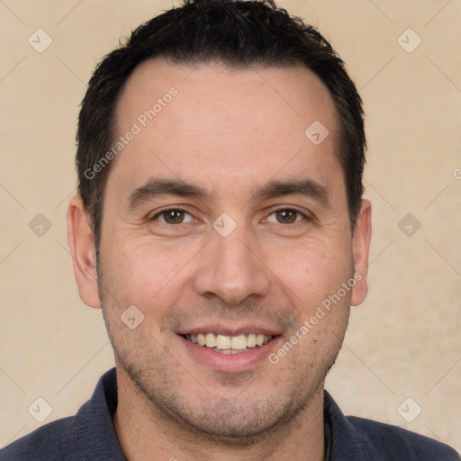 Joyful white adult male with short  black hair and brown eyes