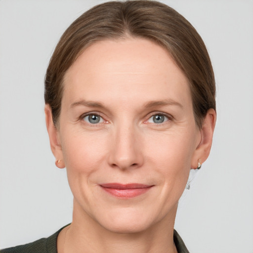 Joyful white adult female with short  brown hair and grey eyes