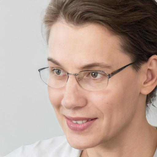 Joyful white adult female with medium  brown hair and blue eyes