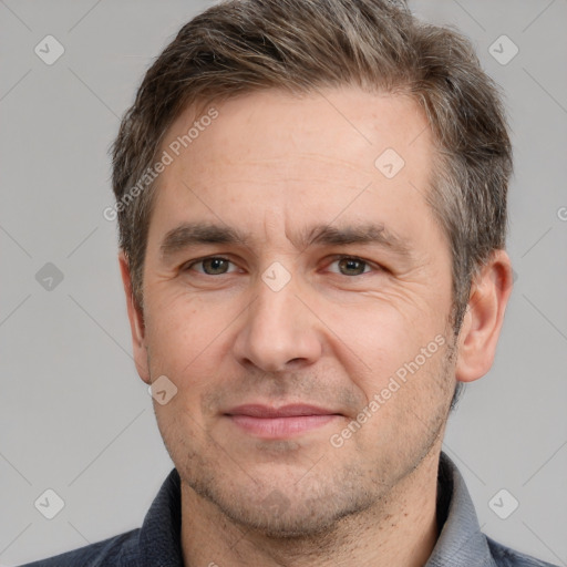 Joyful white adult male with short  brown hair and brown eyes