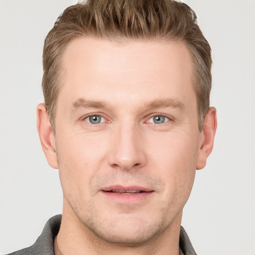 Joyful white adult male with short  brown hair and grey eyes