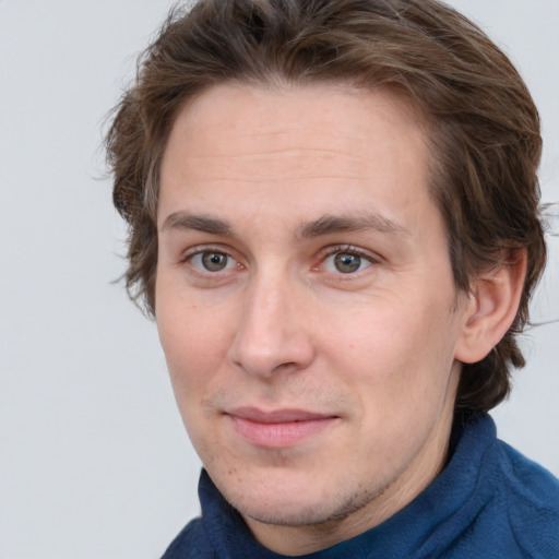 Joyful white adult male with medium  brown hair and grey eyes