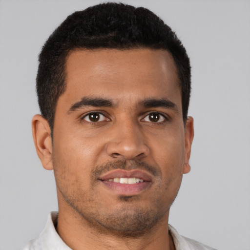 Joyful latino young-adult male with short  brown hair and brown eyes