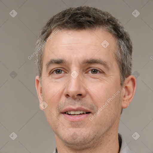 Joyful white adult male with short  brown hair and brown eyes