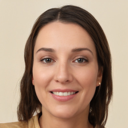 Joyful white young-adult female with medium  brown hair and brown eyes