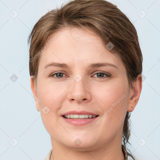 Joyful white young-adult female with short  brown hair and grey eyes