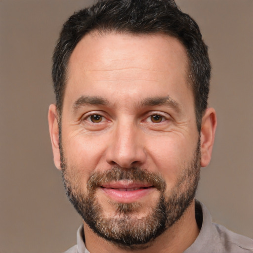 Joyful white adult male with short  brown hair and brown eyes