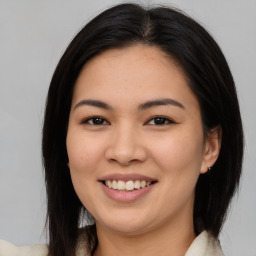 Joyful latino young-adult female with medium  brown hair and brown eyes