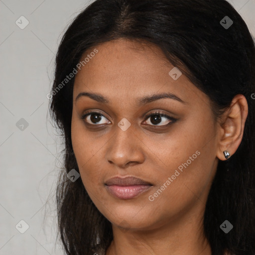 Joyful latino young-adult female with long  brown hair and brown eyes