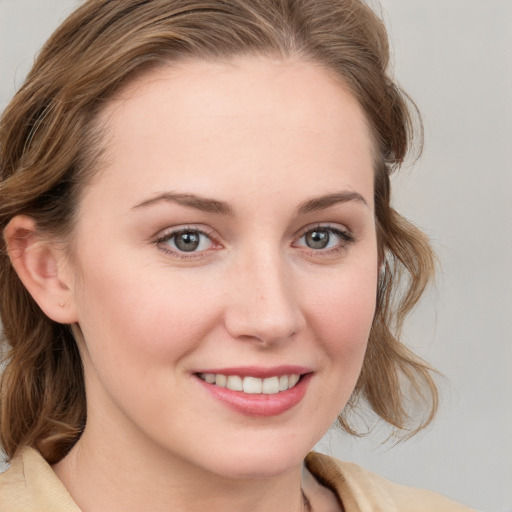 Joyful white young-adult female with medium  brown hair and blue eyes