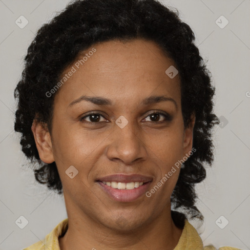 Joyful black adult female with short  brown hair and brown eyes