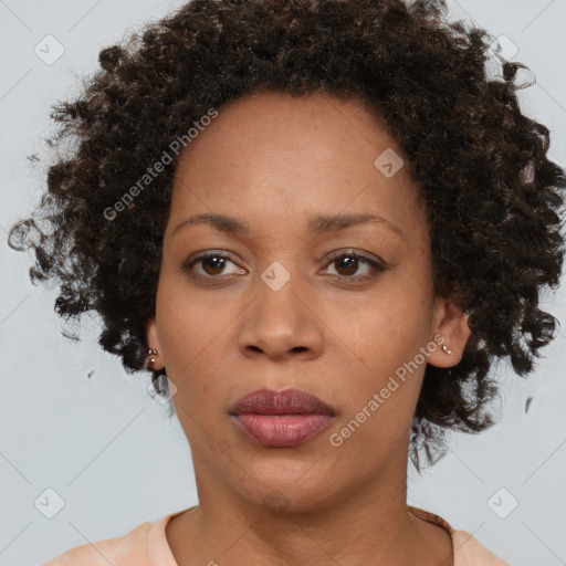 Joyful black adult female with short  brown hair and brown eyes