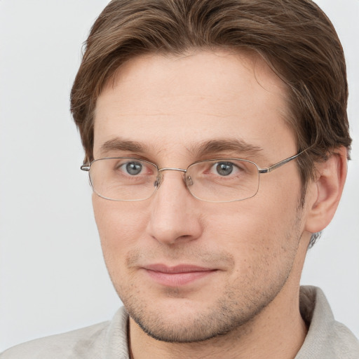 Joyful white adult male with short  brown hair and grey eyes